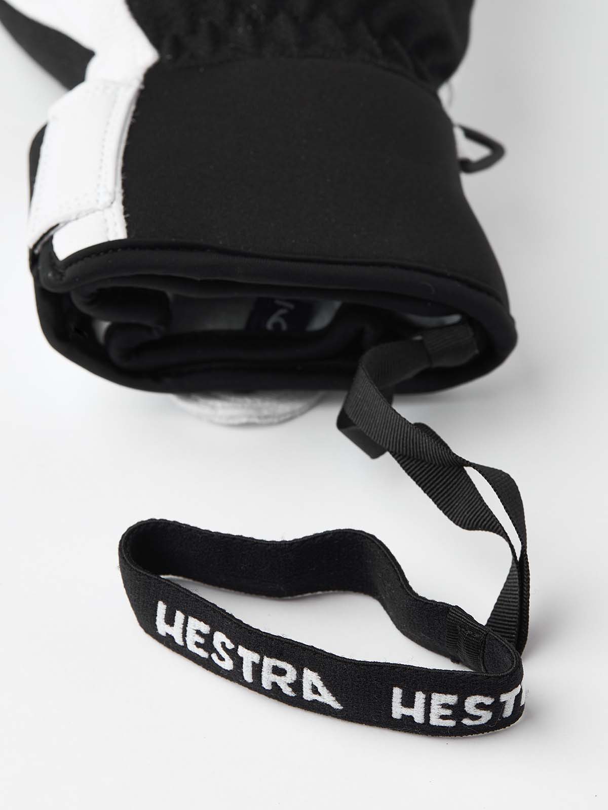 ArmyLeatherPatrolMitt-Pair of white and black mittens with a visible brand logo on a white background