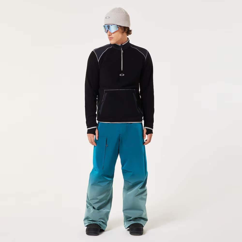 ButterTechFleece-Person wearing black fleece and blue pants with a white background