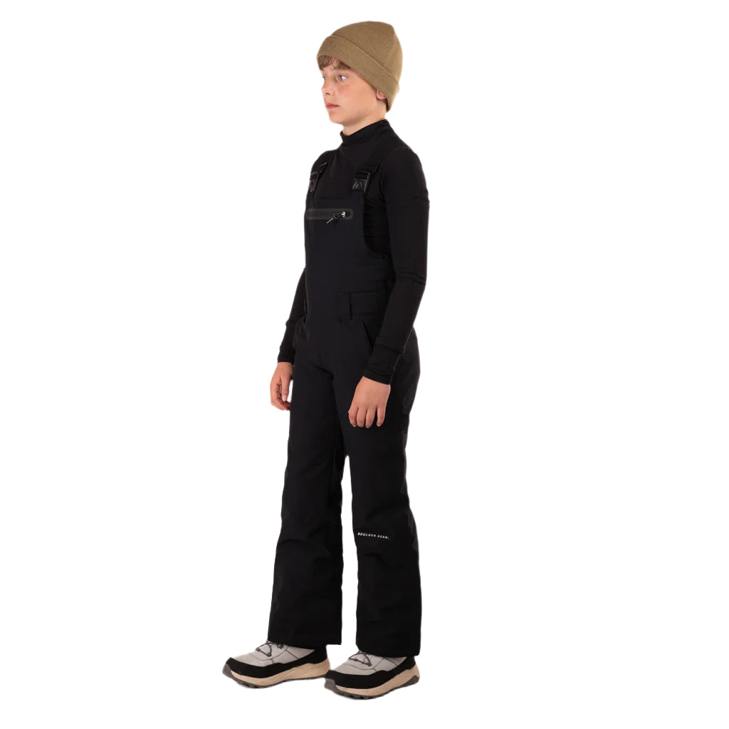 CooperBib-Person wearing a black snowsuit and beige beanie on a white background
