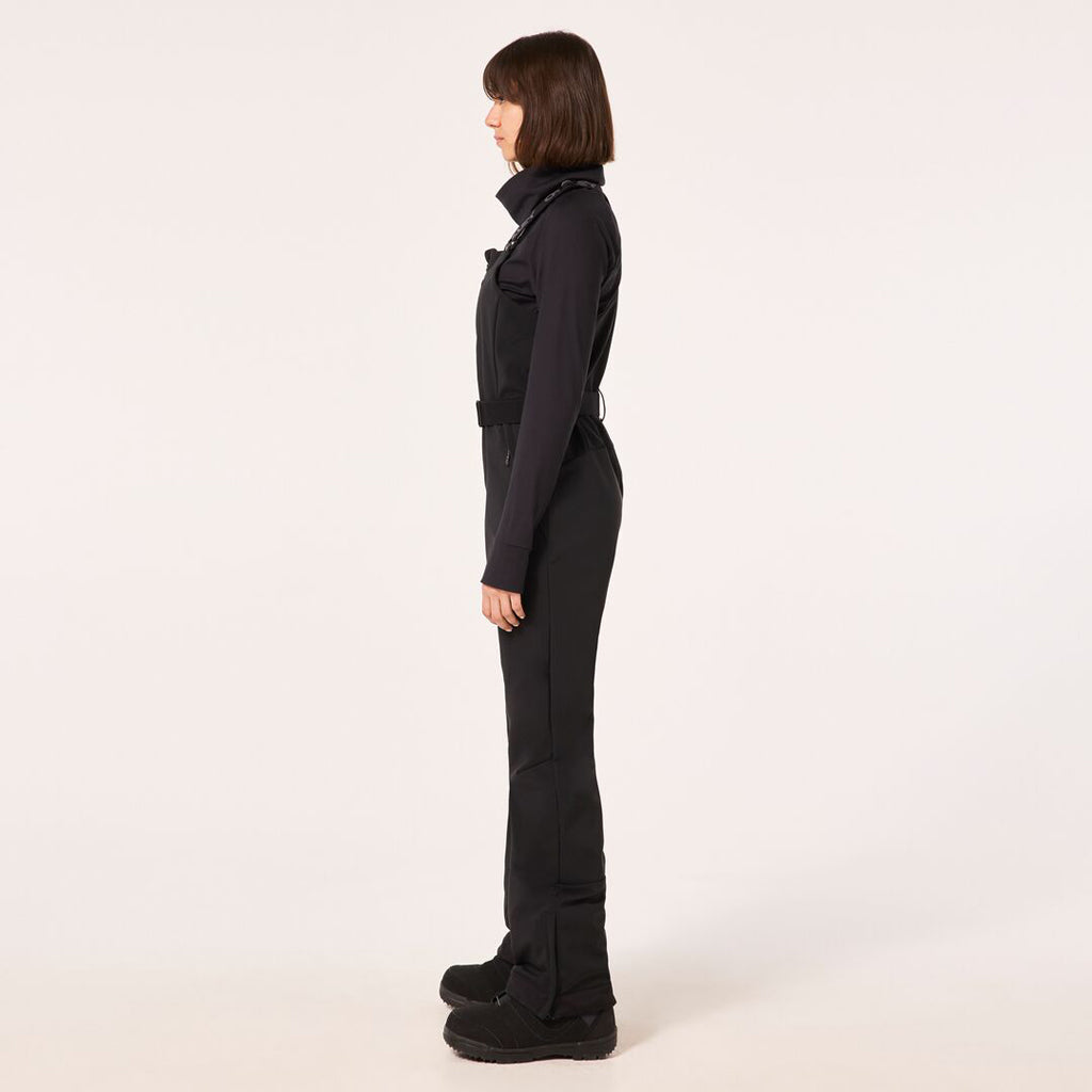 WTNPHarperSoftshellBib-Black ski jumpsuit with a belt on a light gray background