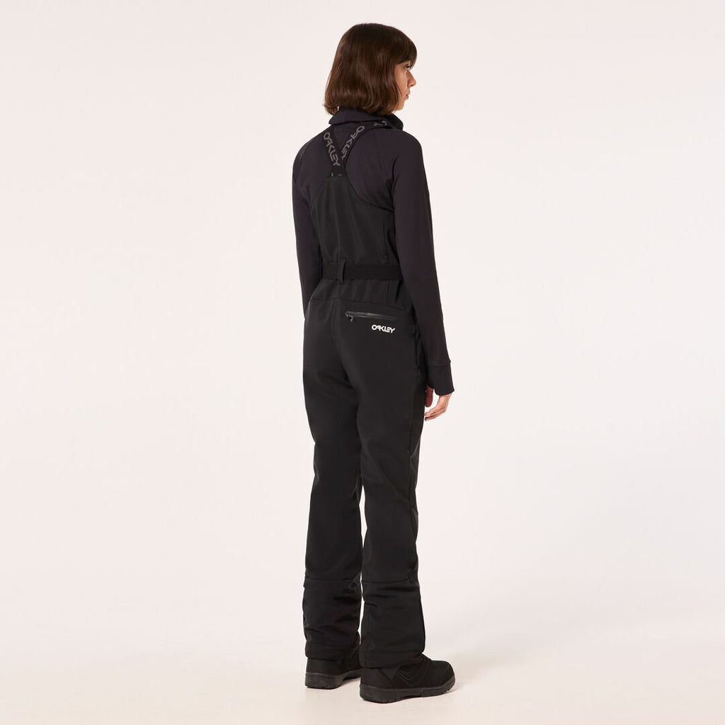 WTNPHarperSoftshellBib-Black ski jumpsuit with a belt on a light gray background
