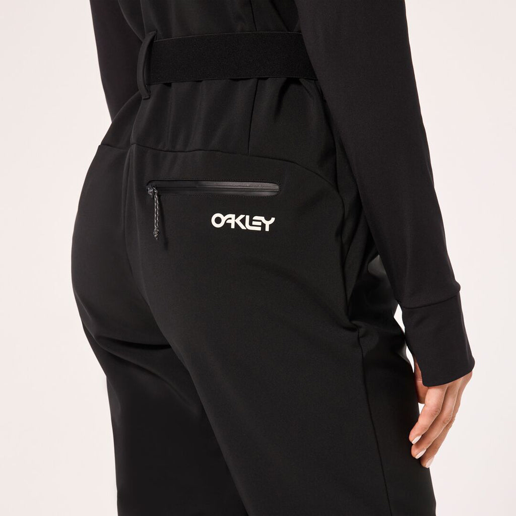 WTNPHarperSoftshellBib-Black ski jumpsuit with a belt on a light gray background