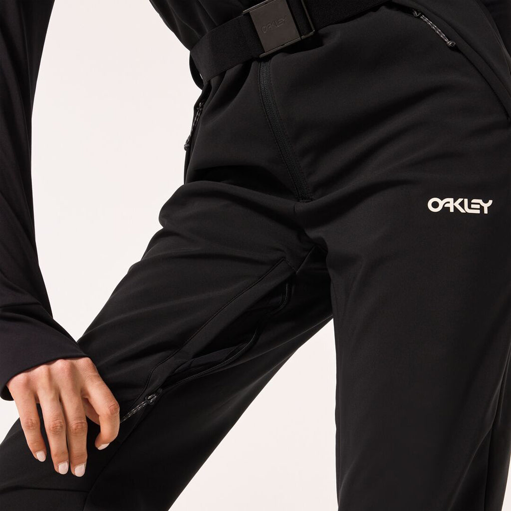 WTNPHarperSoftshellBib-Black ski jumpsuit with a belt on a light gray background