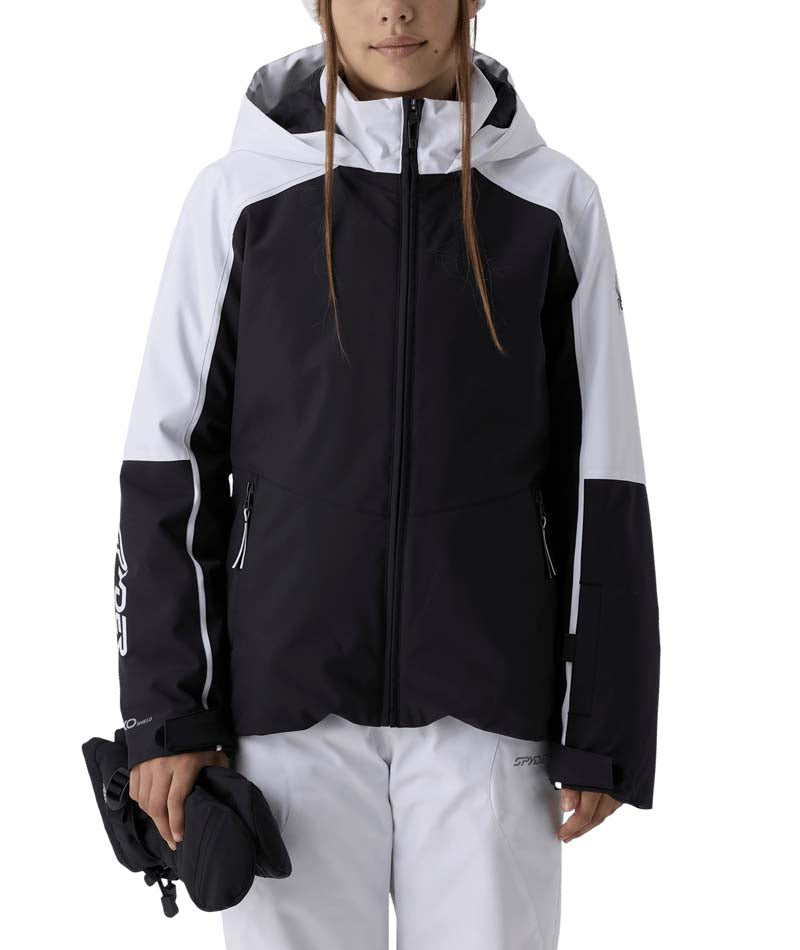 GirlsConquerJacket- Girl wearing a black and white ski jacket on a white background
