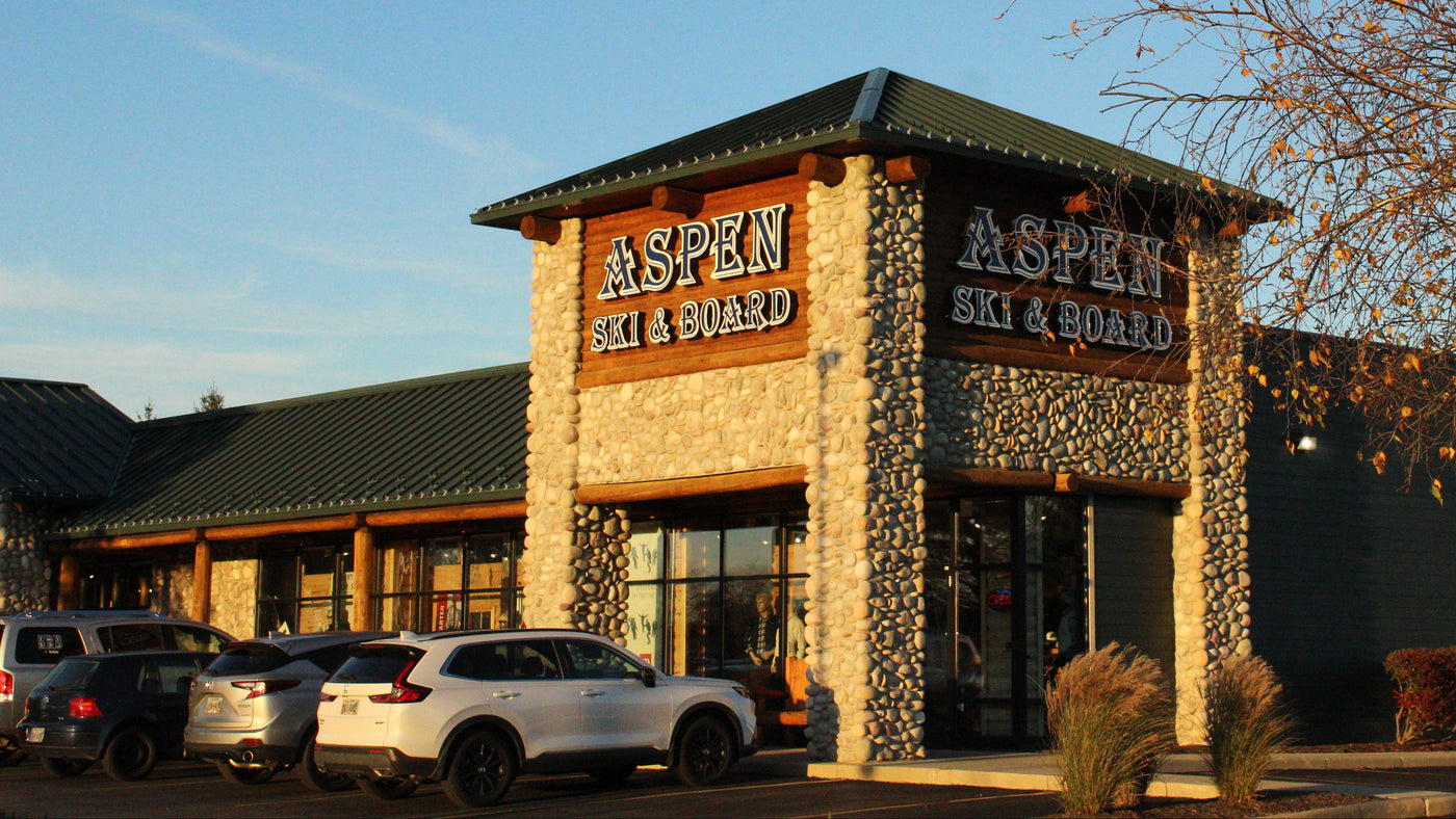 Aspen Ski & Board store exterior with cars parked outside on a clear day.