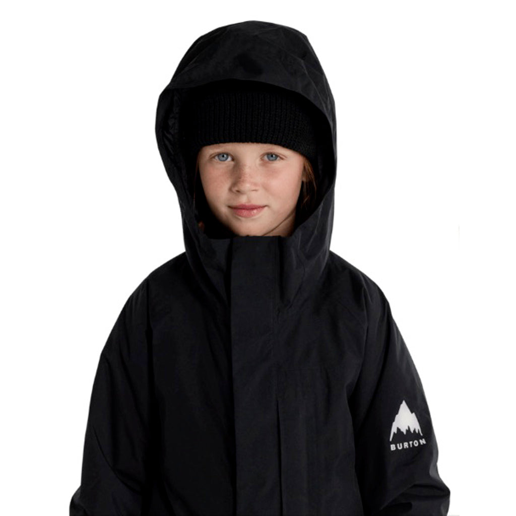 KPowlineGORE-TEX2LJacket-Child wearing a black hooded jacket with a visible brand logo on a white background