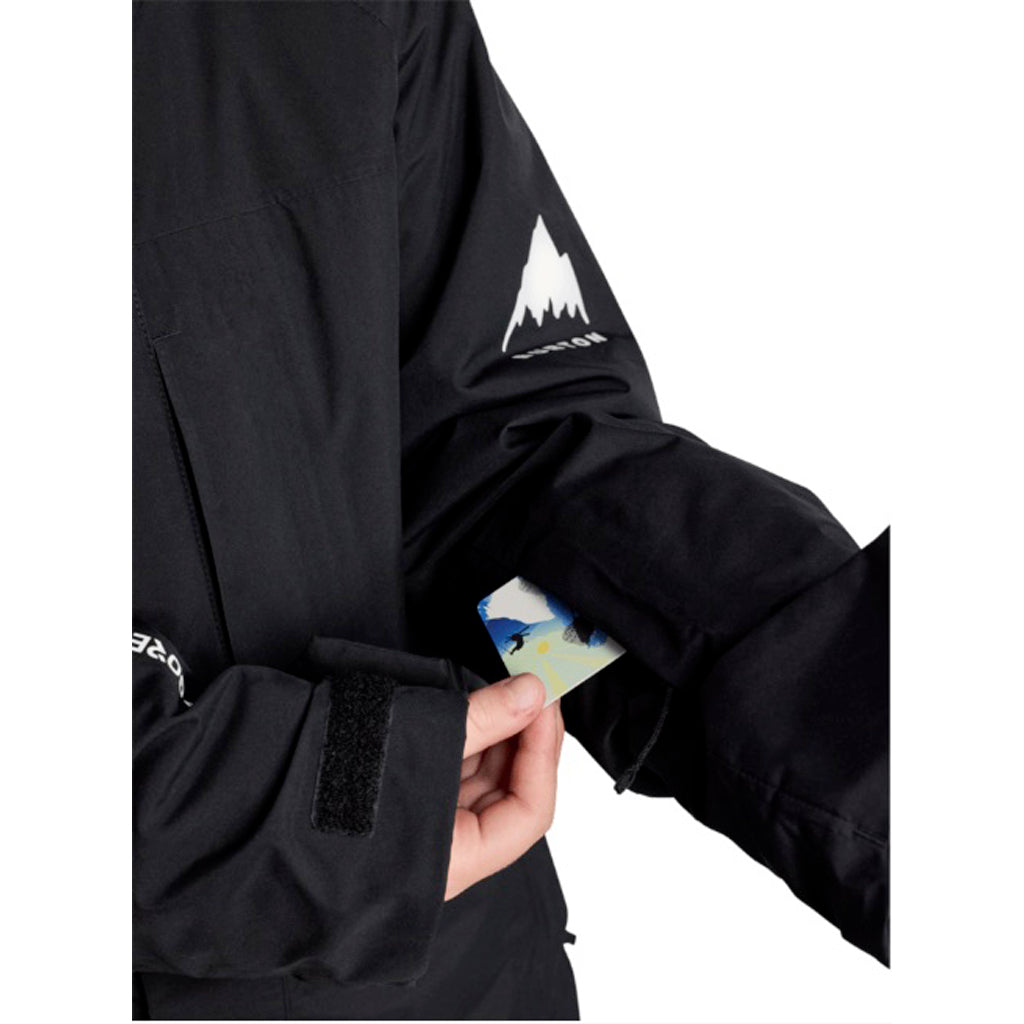 KPowlineGORE-TEX2LJacket-Black jacket with a visible brand logo on the sleeve, held open to show a card inside.
