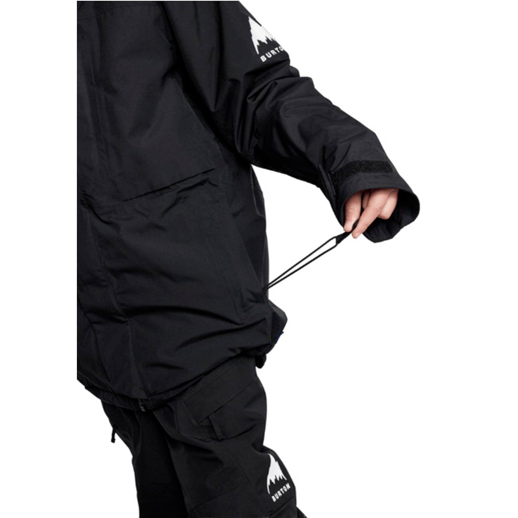 KPowlineGORE-TEX2LJacket-Person wearing a black snowboard jacket with a brand logo on a white background