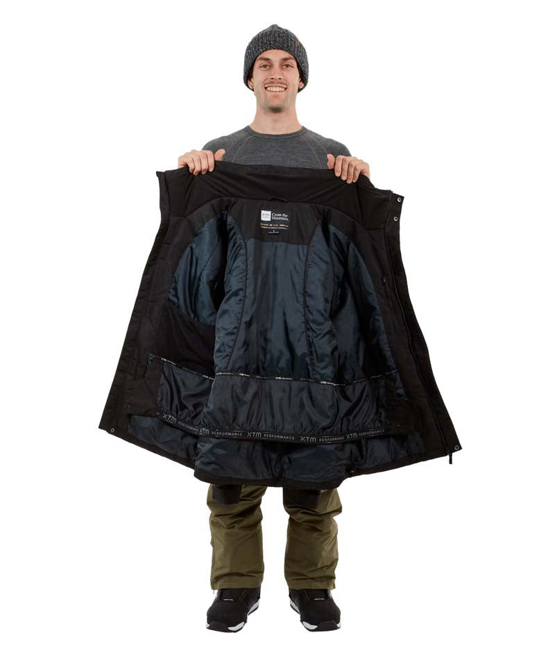 KnoxJacket-A man wearing a black snowboard jacket, black beanie with goggles, and gray gloves, standing against a solid white background.