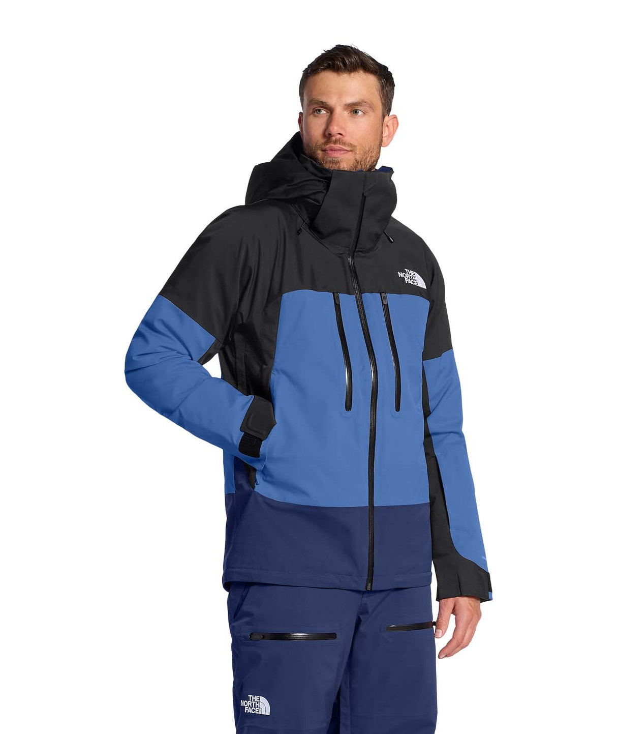 MChakalJacket-Person wearing a blue and black jacket with The North Face logo on a white background