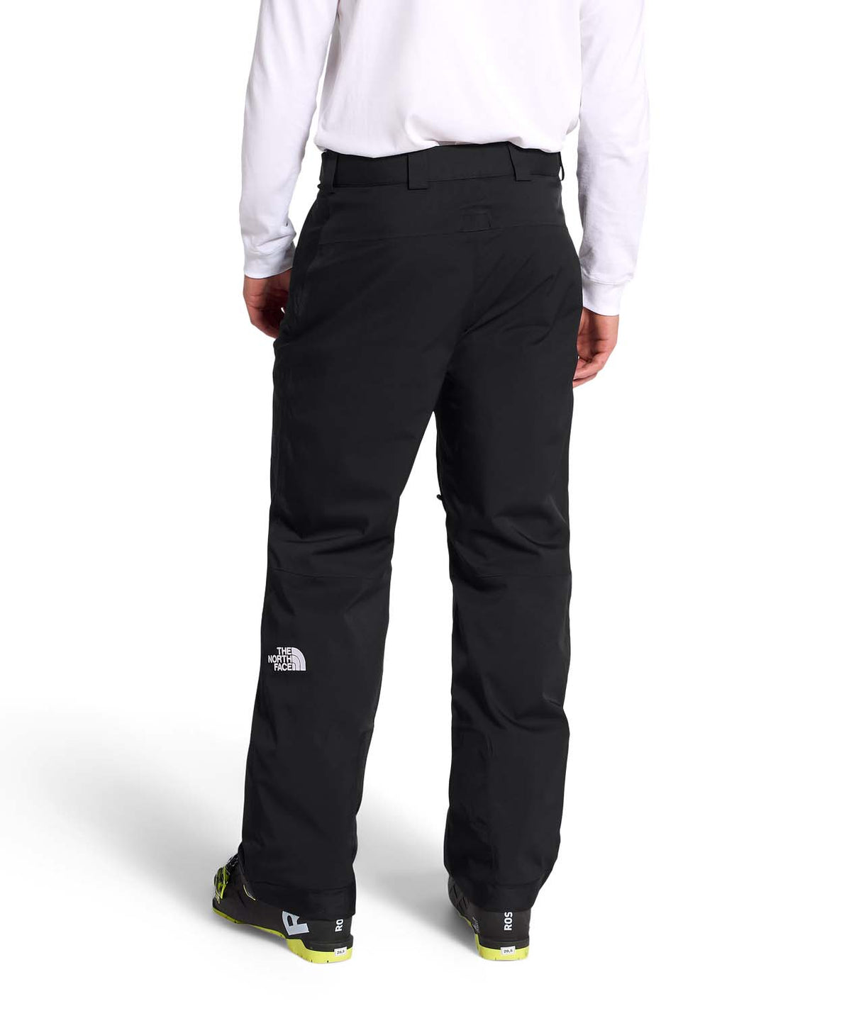 MChakalPant- Man wearing black snow pants with The North Face logo on a white background