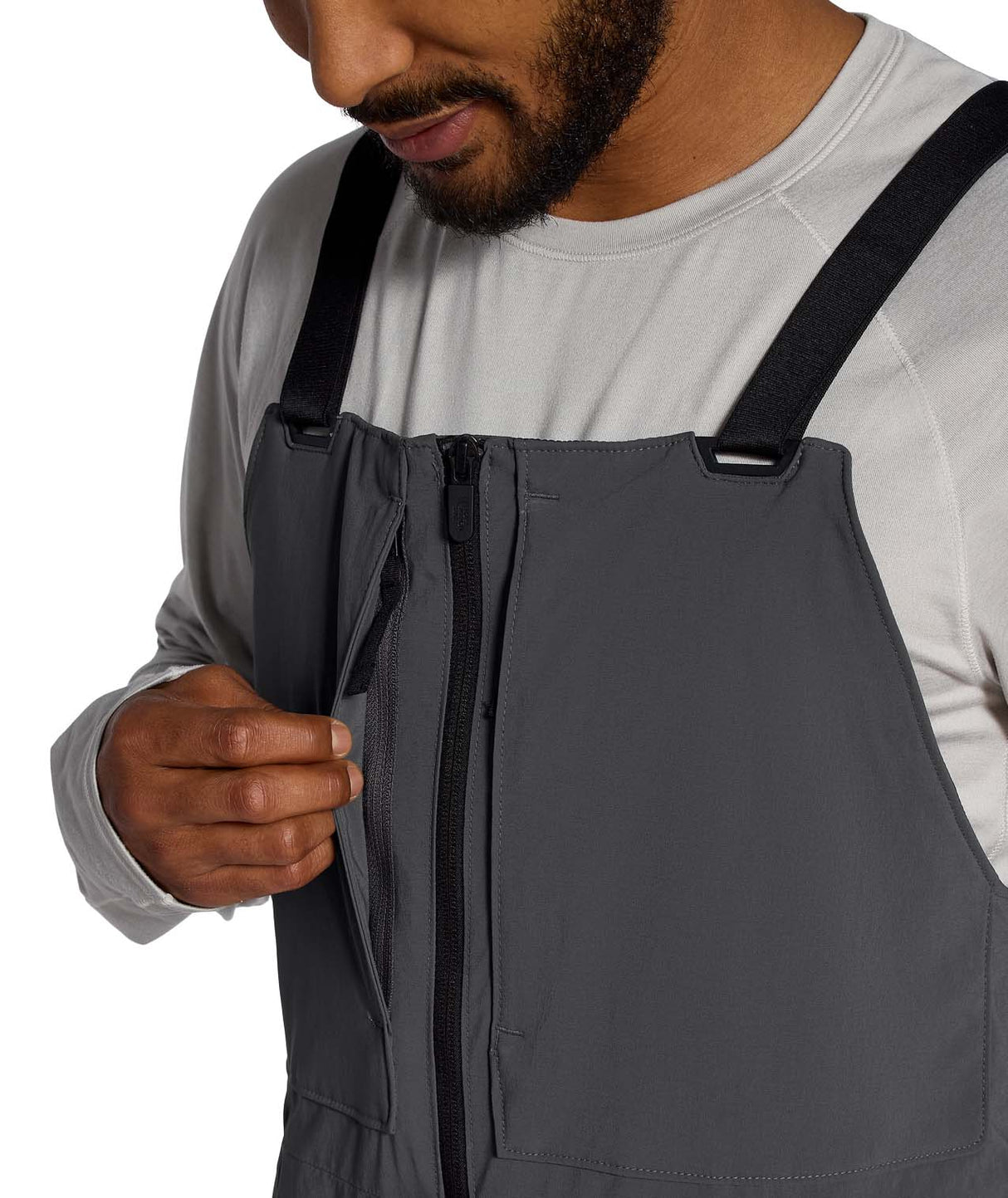 MFreedomBib- Man wearing grey bib overalls with The North Face logo on a white background