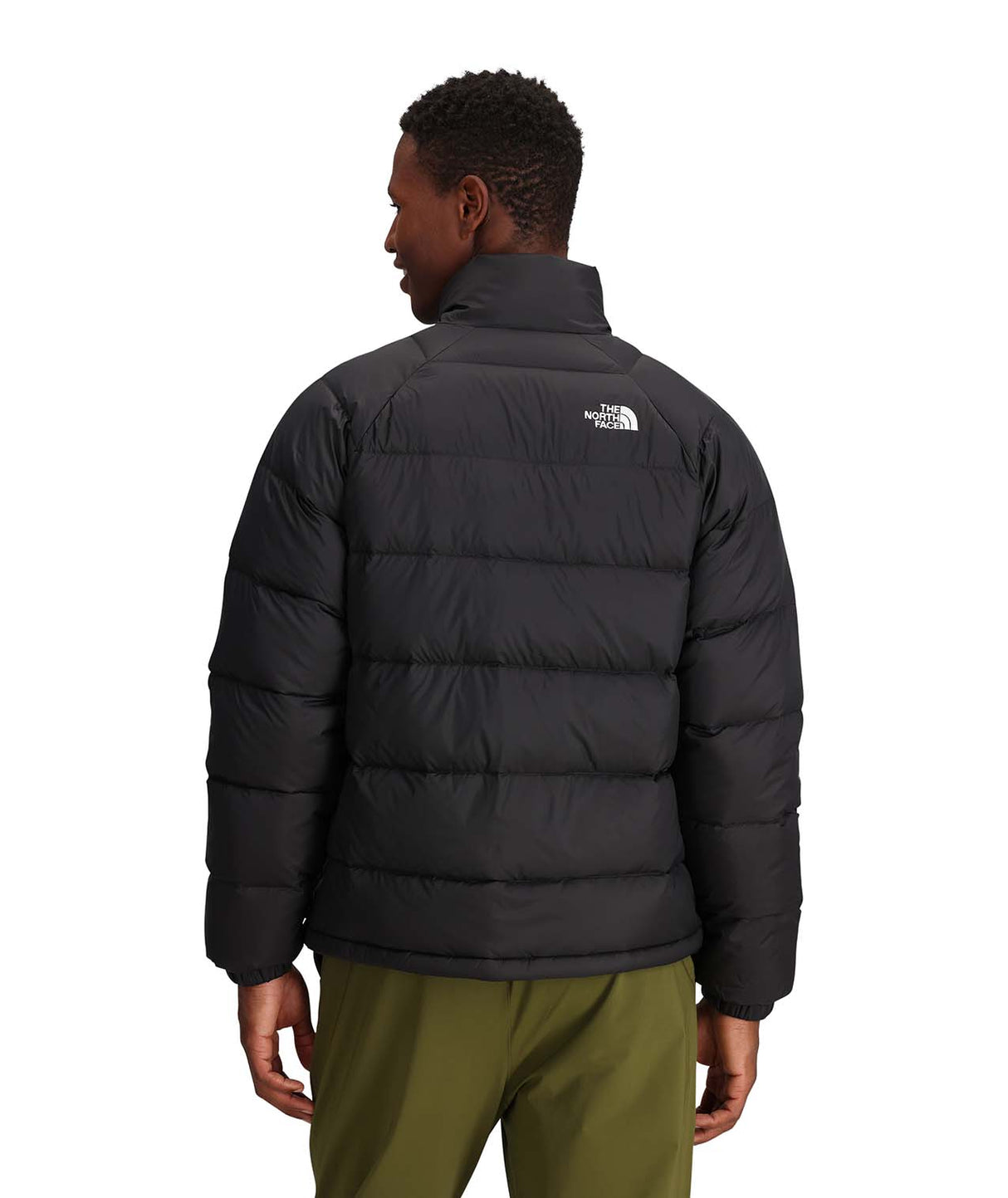 MHydrenaliteDownJacket-Person wearing a black puffer jacket with a brand logo on the back, standing against a white background.