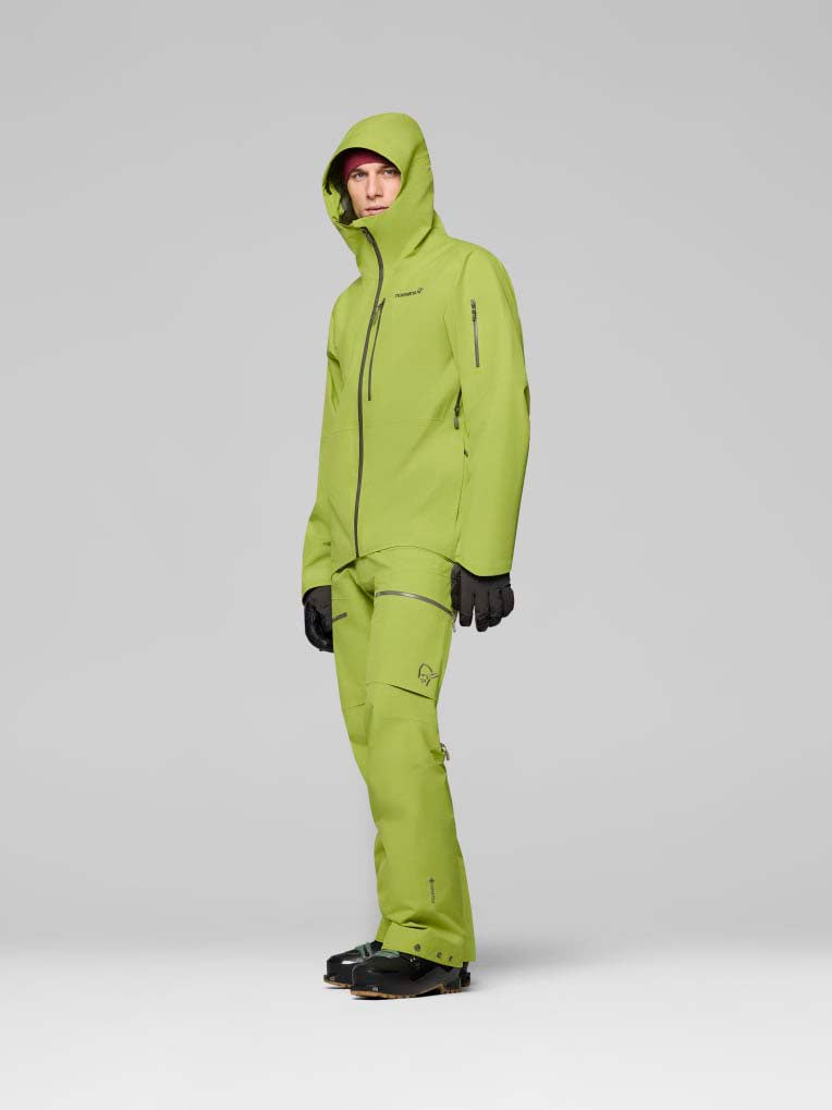 LofotenGore-TexJkt-Person wearing a green ski jacket on a gray background