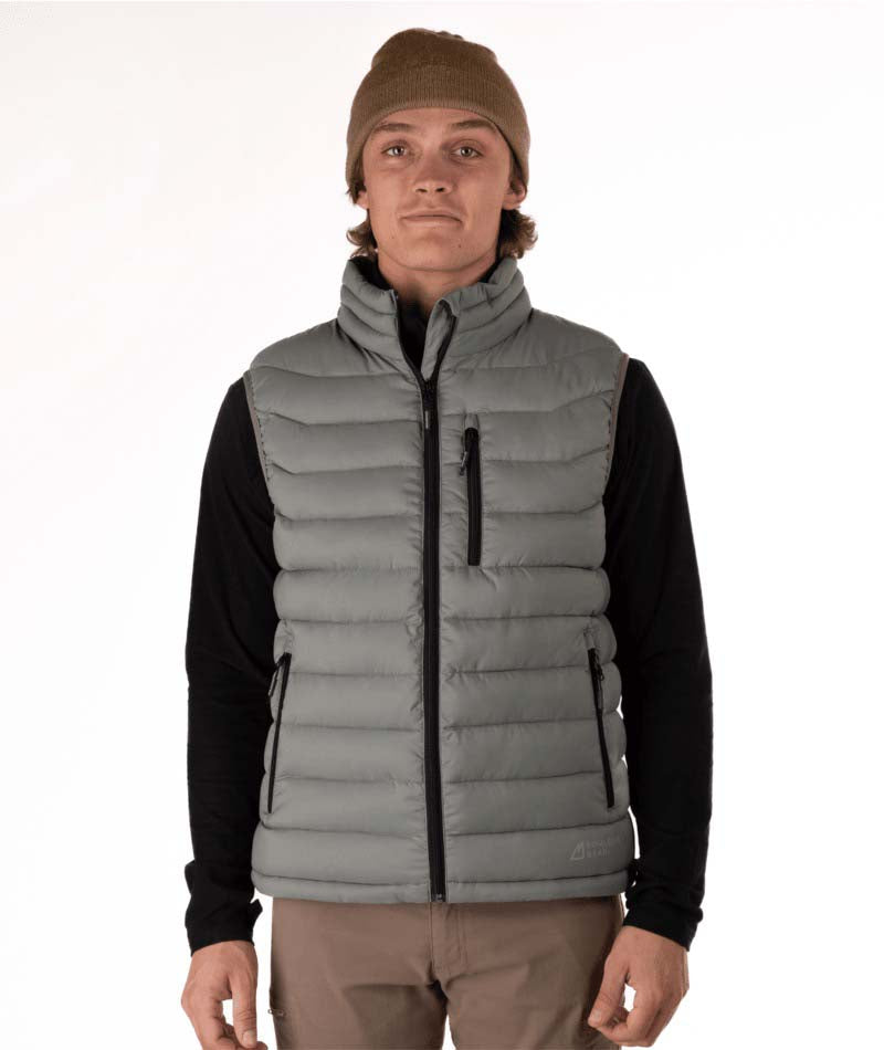 MSawyerPuffyVest-Man wearing a grey puffer vest over a black shirt on a white background
