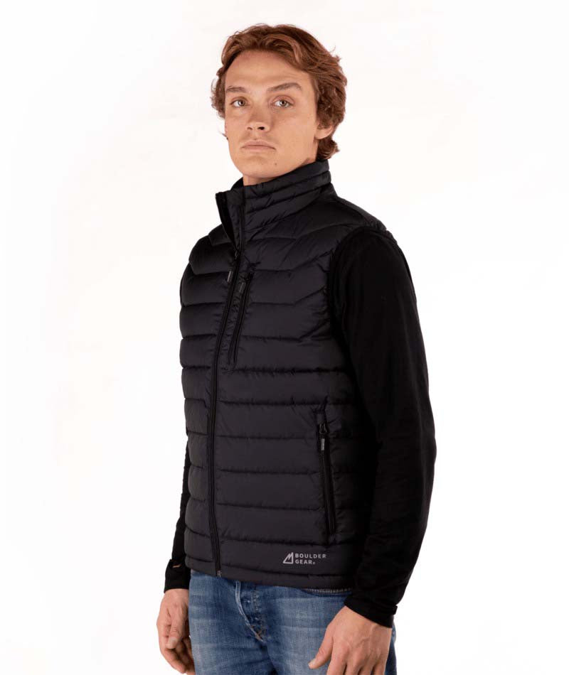 MSawyerPuffyVest-Man wearing a black puffer vest over a black shirt on a white background