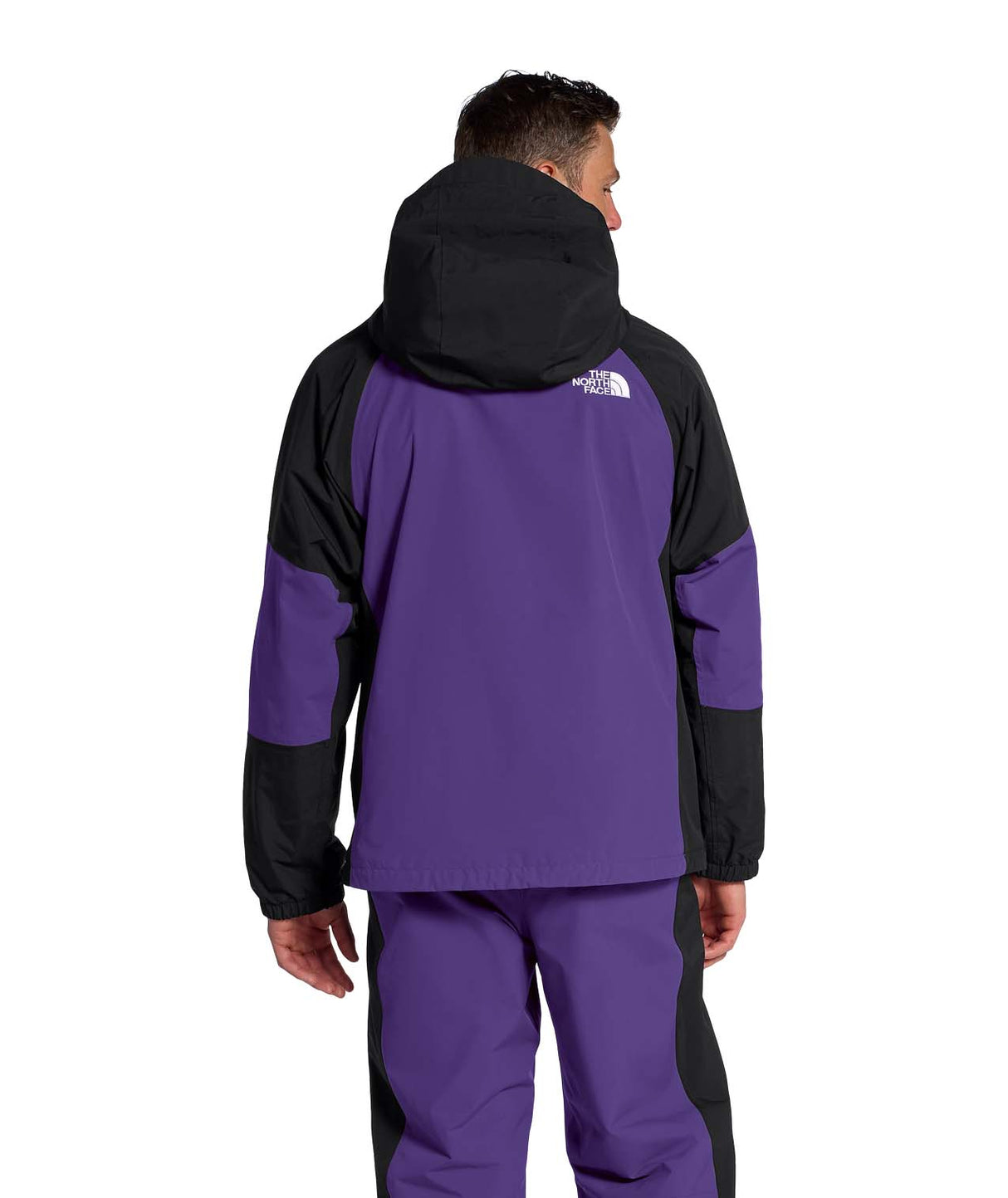 MSliderJacket-Man wearing a purple and black jacket with The North Face logo on a white background
