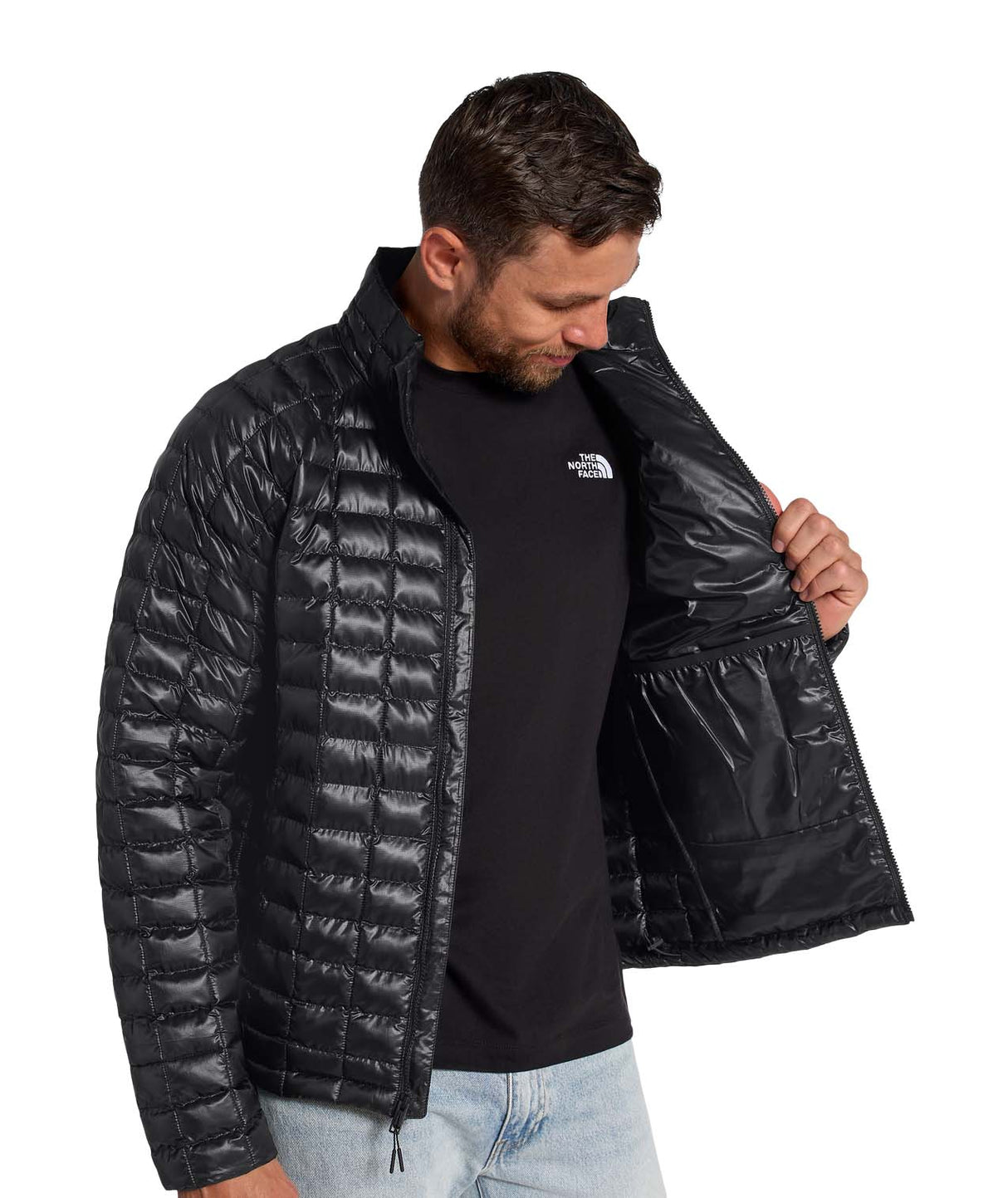 MTHERMOBALLJacket-Man wearing a black quilted jacket with a brand logo on a white background