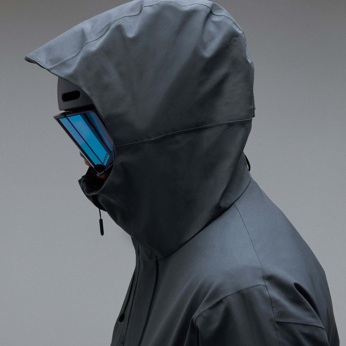 MTimberlineShellAnorak-A dark gray hooded jacket with a large tonal Oakley logo on the chest, displayed against a neutral gray background.