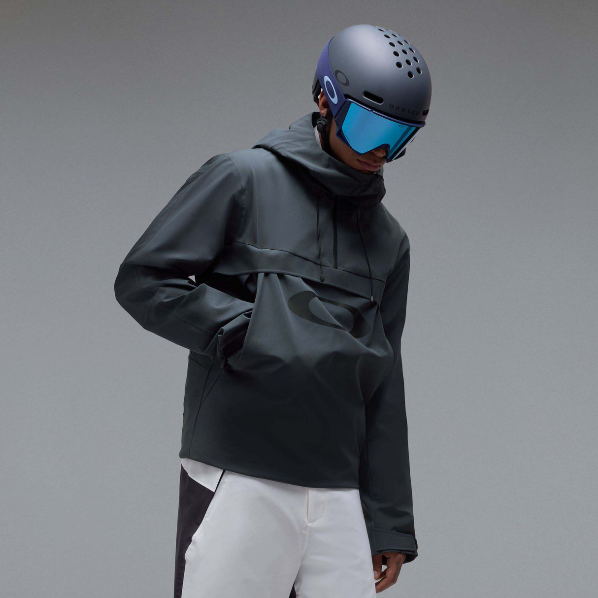 MTimberlineShellAnorak-A dark gray hooded jacket with a large tonal Oakley logo on the chest, displayed against a neutral gray background.