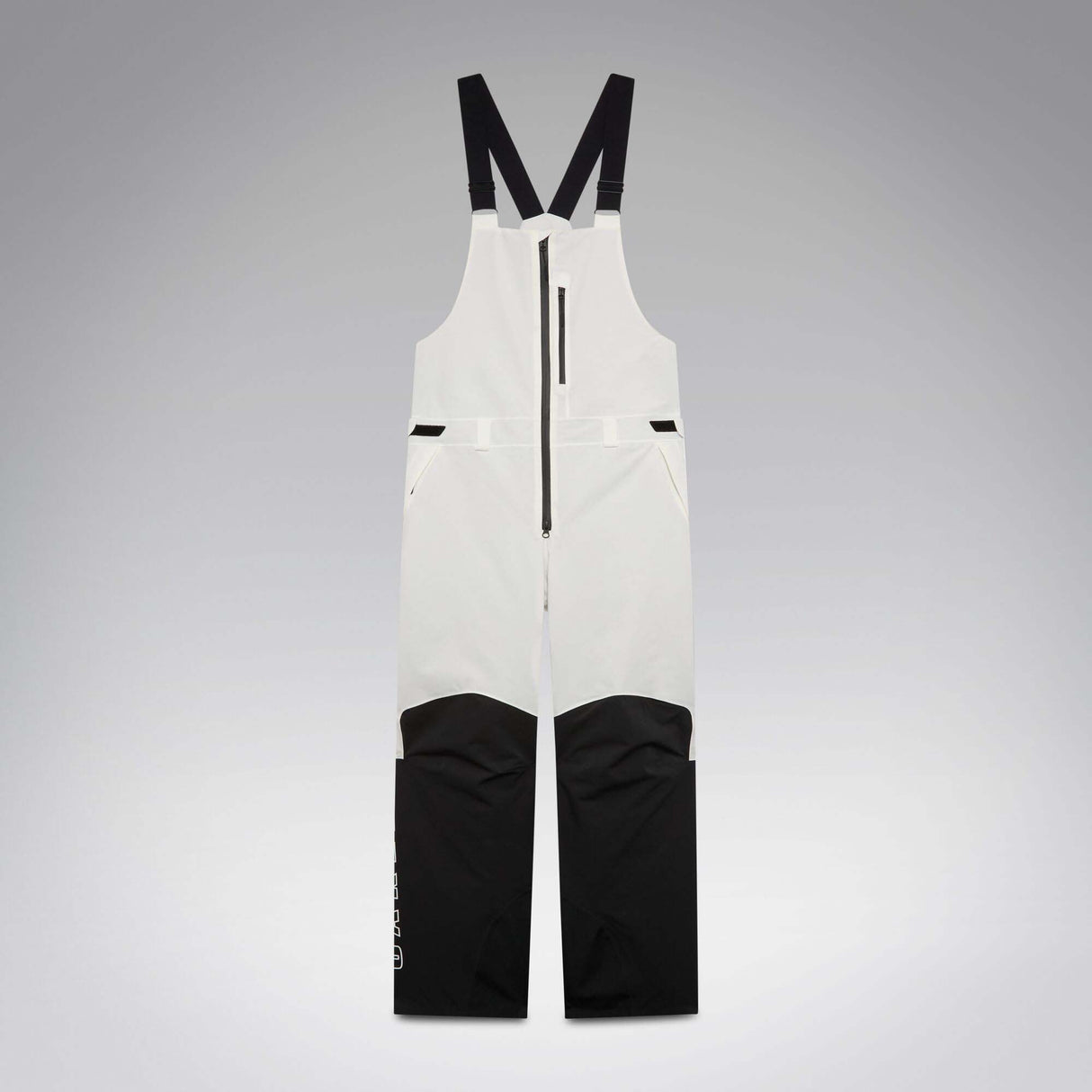 MTimberlineShellBib-A white and black technical snow bib with adjustable shoulder straps, a front zipper, and reinforced lower leg panels, shown against a neutral gray gradient background.