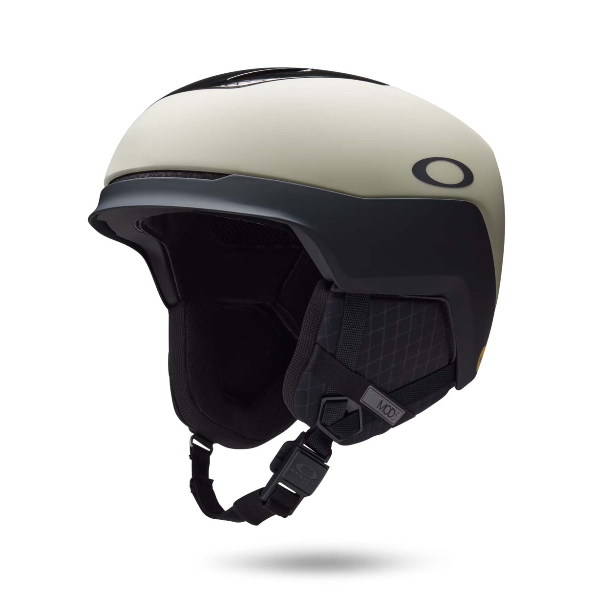 Mod5-Oakley ski helmet in off-white and black, featuring a matte finish, integrated visor, and black chin strap on a white background.