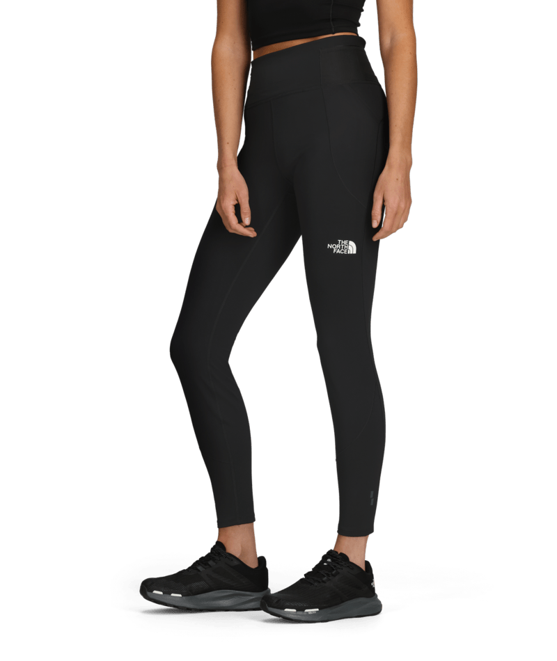 W Winter Warm Pro Tight-Person wearing black leggings with a brand logo on a transparent background