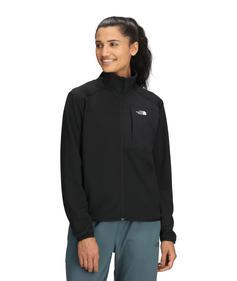 W TNF Performance Fleece Full Zip Jacket-Woman wearing a black jacket with a brand logo on a transparent background