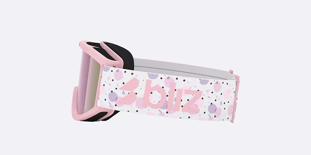 Pixie-Bliz ski goggles in matte pink with a mirrored pink lens and a matching pink strap, shown on a light gray background.