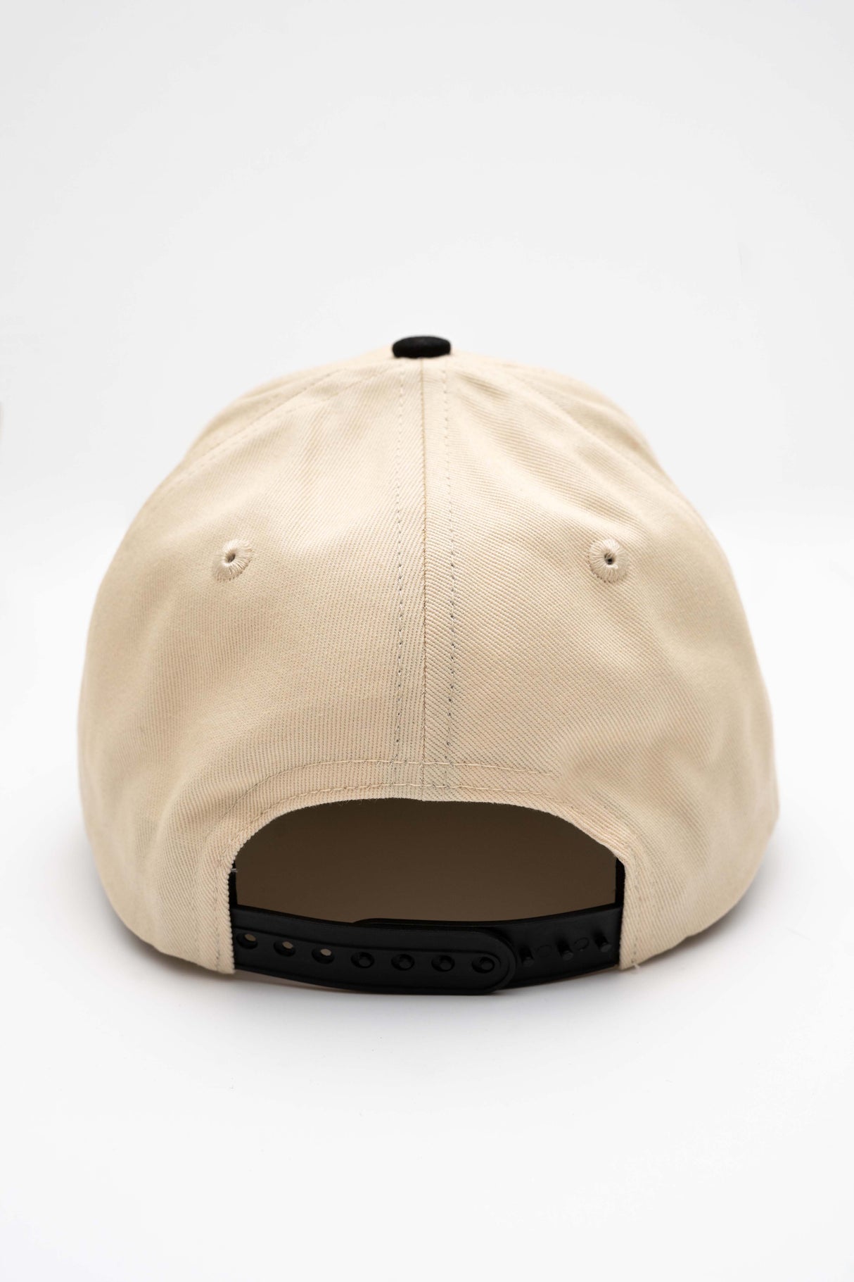 ScriptCap-A baseball cap with a cream-colored crown and a black curved brim, featuring the word 'Public' embroidered in red script on the front. The cap is photographed on a seamless white background.