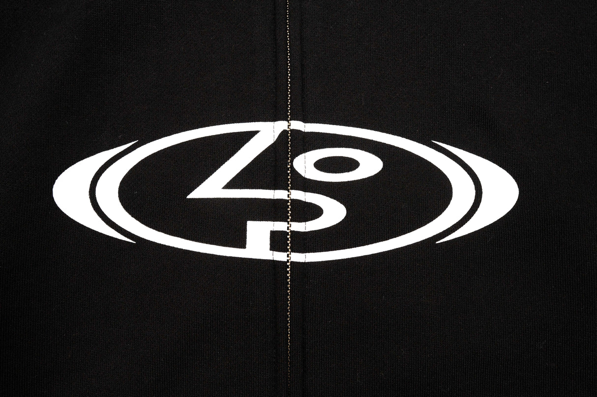 StretchLogoHoody-Close-up of a black garment featuring a large white circular logo with stylized lettering across the chest, centered around the zipper.