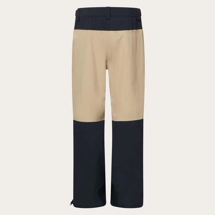 TNPShellPant2.0-Beige and black pants with a brand logo on a light gray background