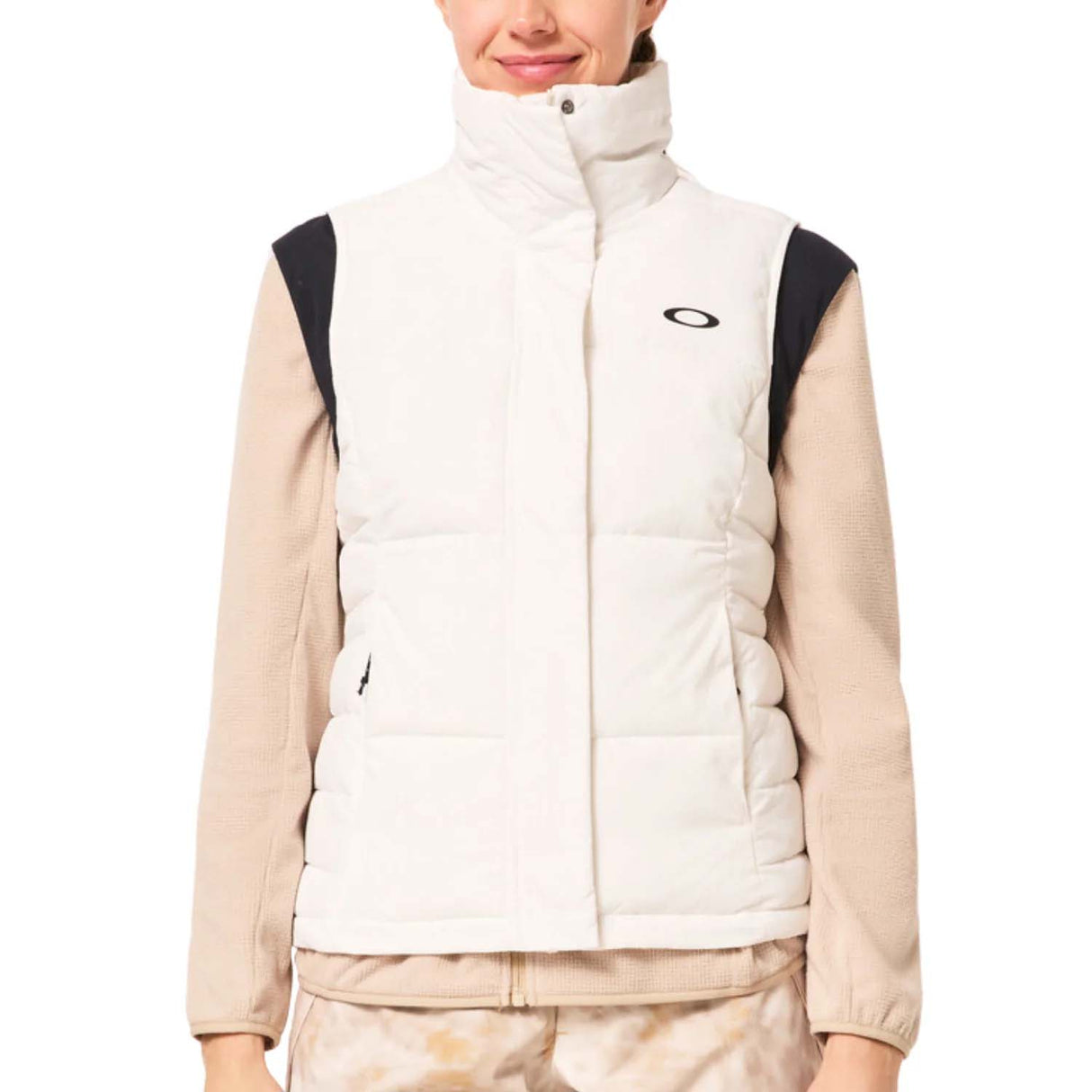 WAutumnRCVest-Person wearing a beige and white puffer vest with a brand logo on a white background