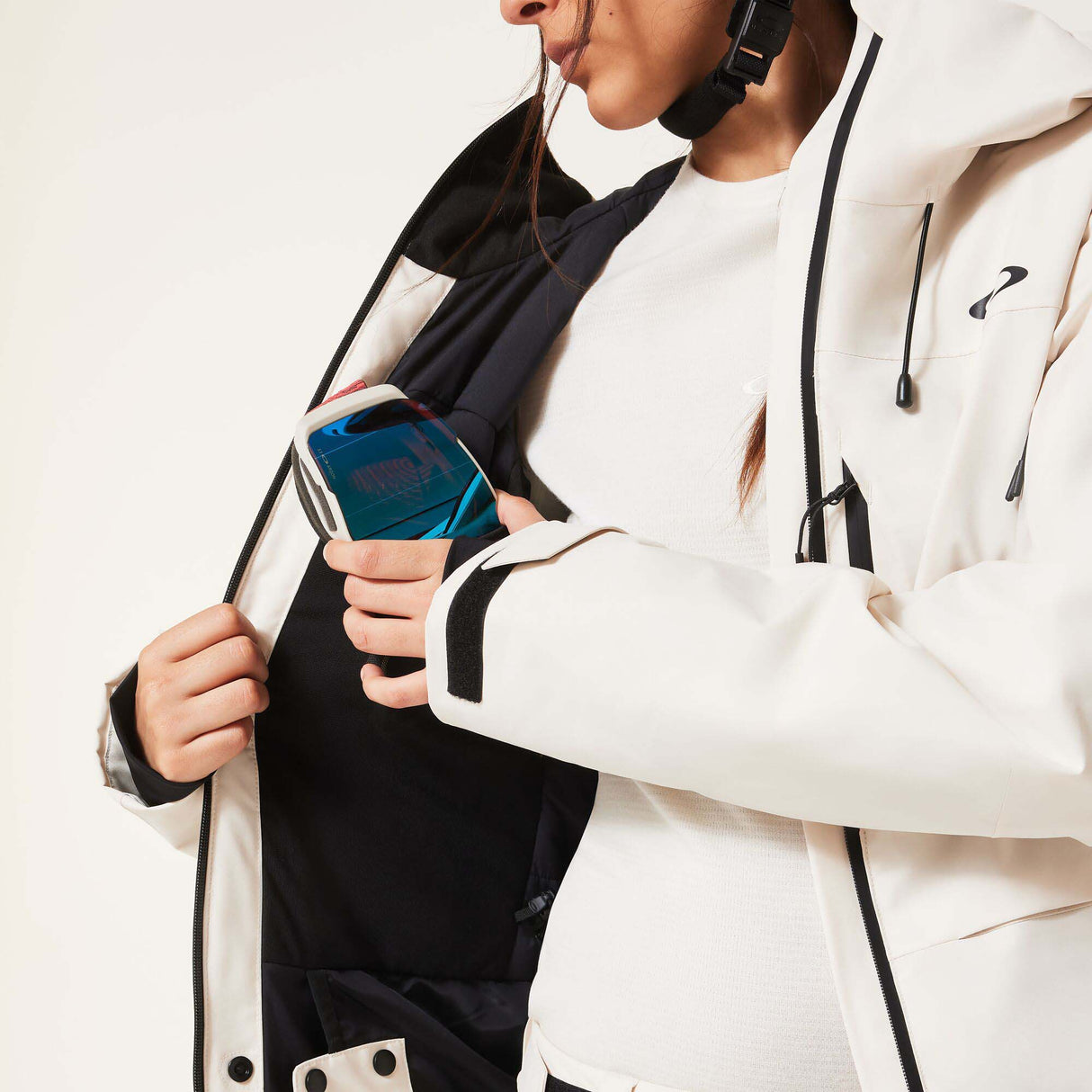 WCanopyInsulatedJacket-An off-white hooded ski jacket with black zipper details and drawstrings, displayed on a neutral light gray background.