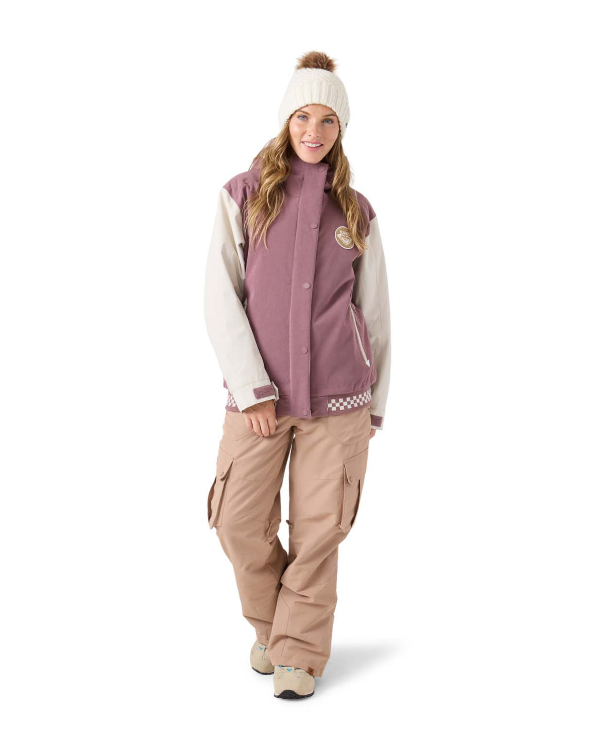 WCheerUpJacket- Woman wearing a pink and cream jacket on a white background