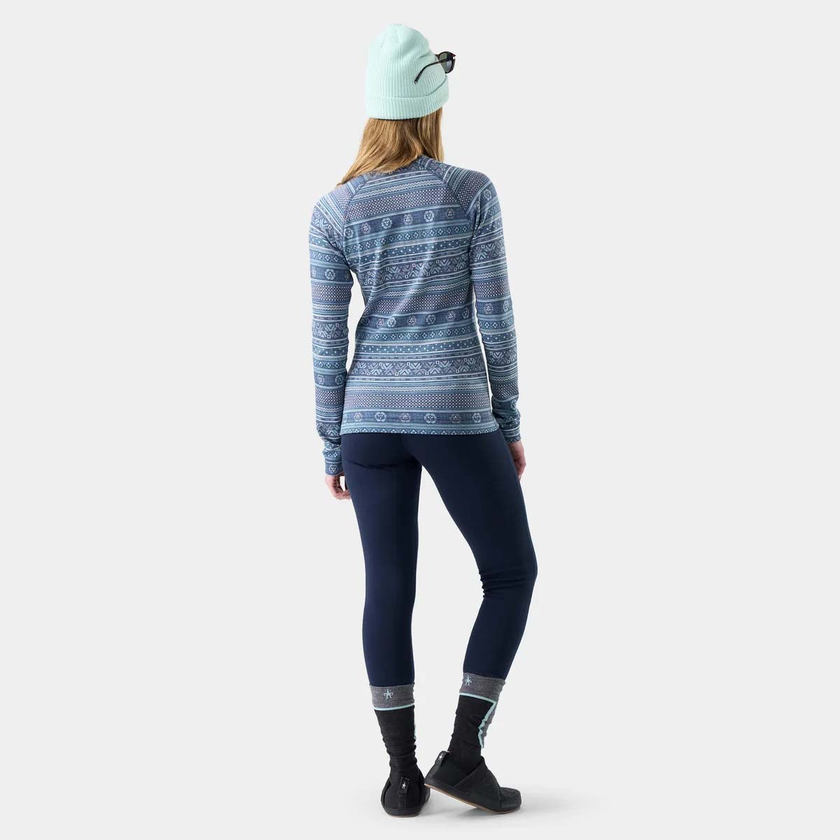 WClassicThermalMerinoBaseLayerCrew- A women's long-sleeve crewneck sweater featuring a horizontal Nordic and Fair Isle style pattern in slate blue, teal, and white.