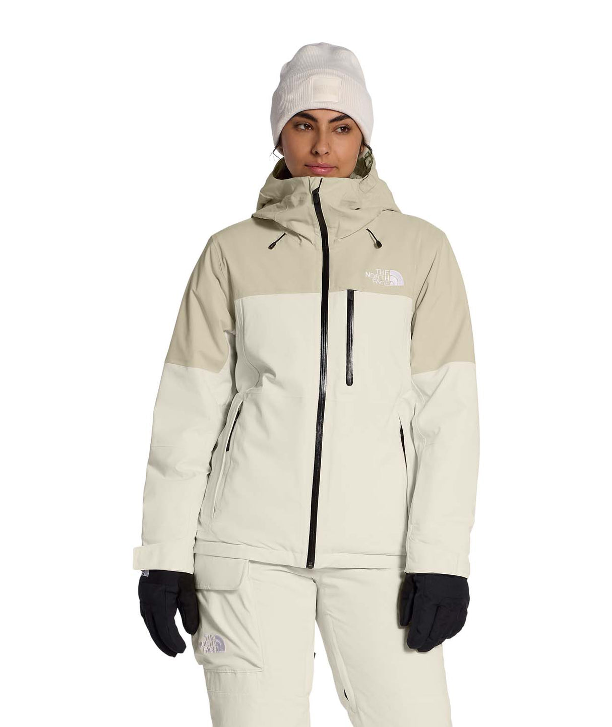 WFreedomInsulatedJacket-Person wearing a beige and white winter jacket with matching pants and hat on a white background