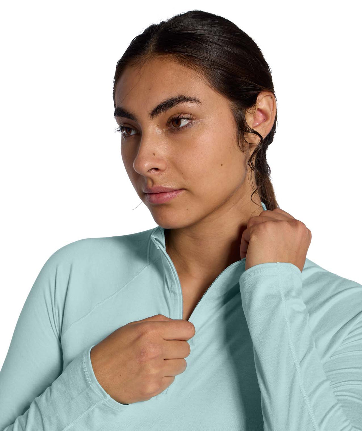 WJaida1_4Zip- Woman wearing a light blue long-sleeve quarter zip shirt on a white background
