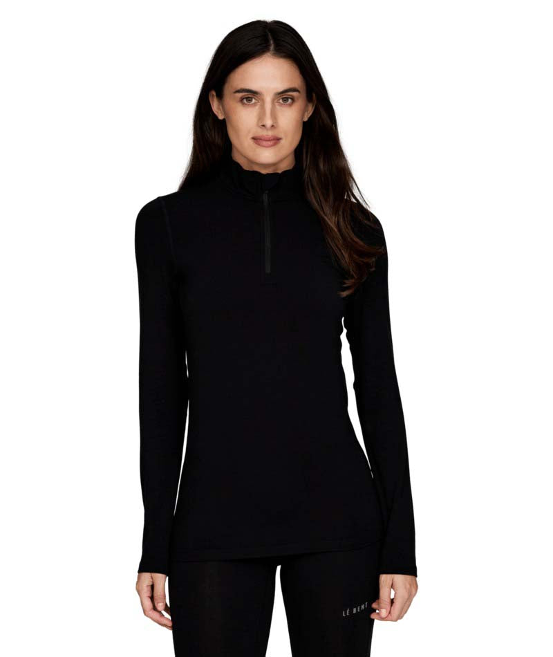 WMidweight1_4Zip-Woman wearing a black long-sleeve athletic top on a white background