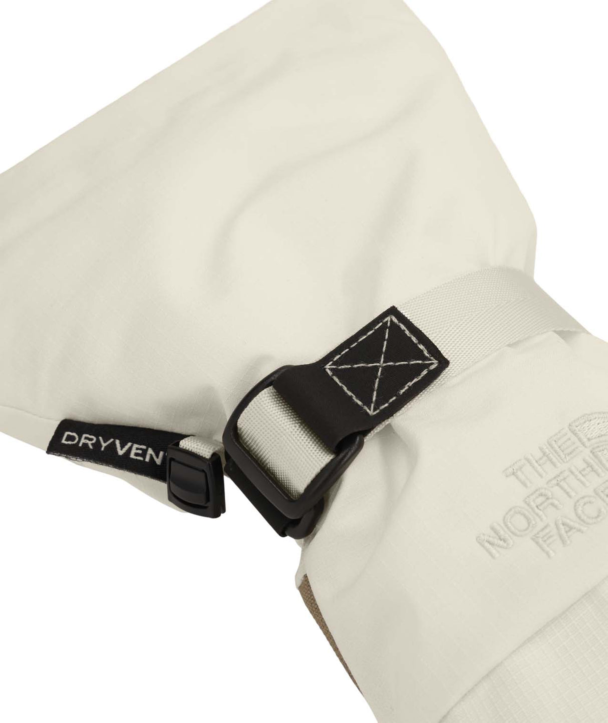 WMontanaMitt-Close-up of a beige jacket with a blackDryveN label and The North Face logo.