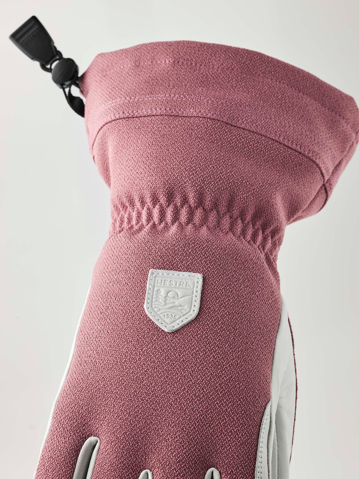 WPatrolGauntletGlove-Pair of pink and white gloves with a visible brand logo on a white background
