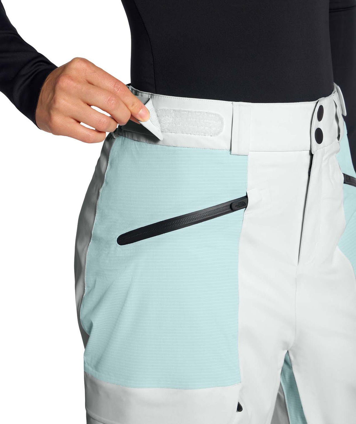 WPowstarPant-Light blue and white pants with a zipper pocket being opened.