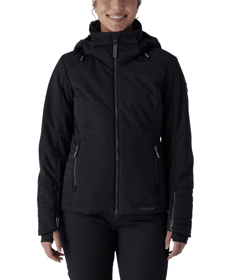 WSchatziJacket- Woman wearing a black ski jacket on a white background