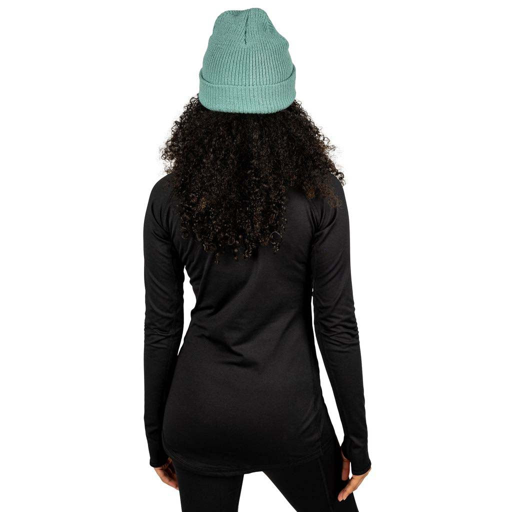 WSkylinerCrewneck-Person wearing a black long-sleeve top and teal beanie on a white background