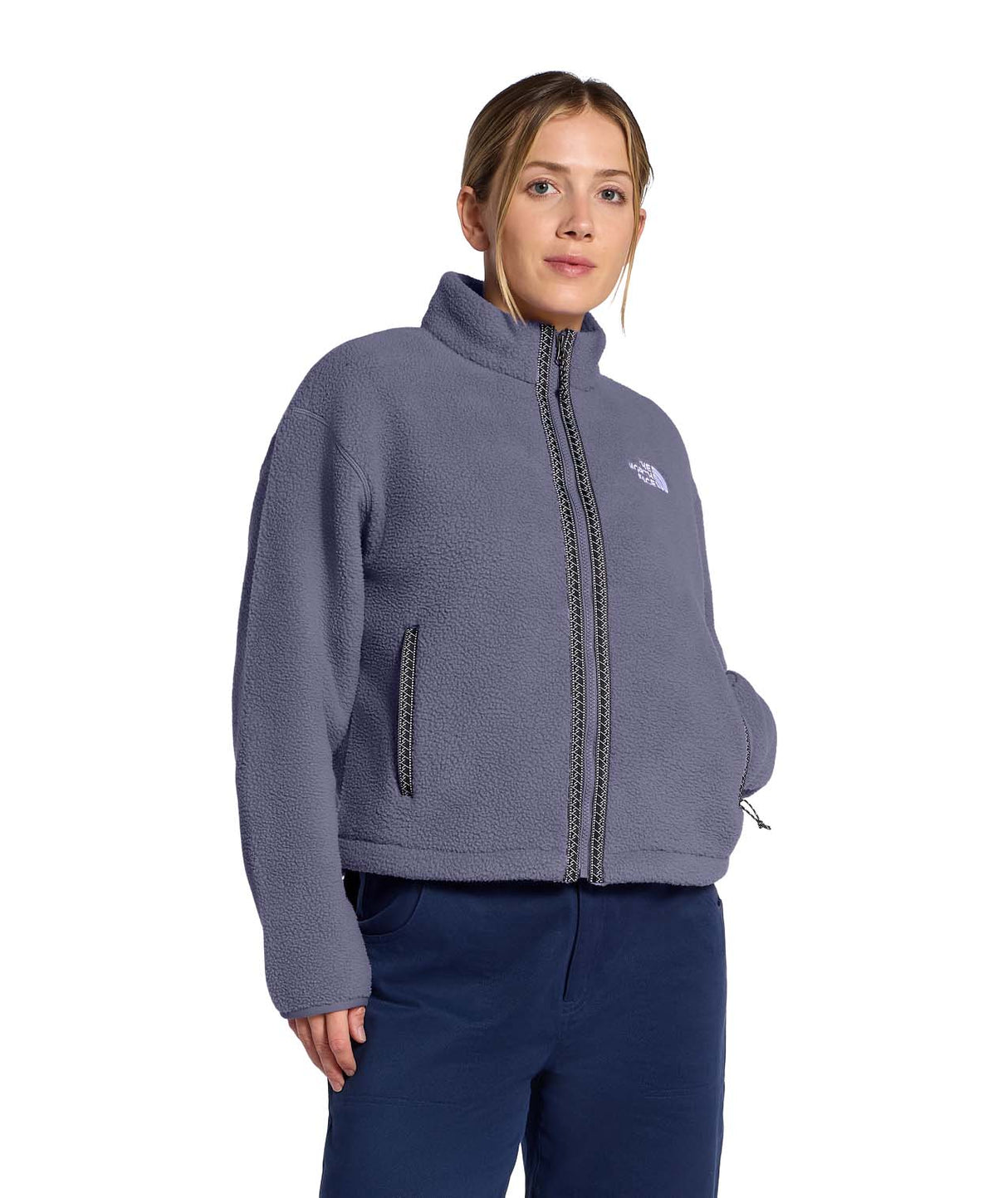 WTNFFleeskiFullZipJacket- Person wearing a purple fleece jacket with The North Face logo on a white background