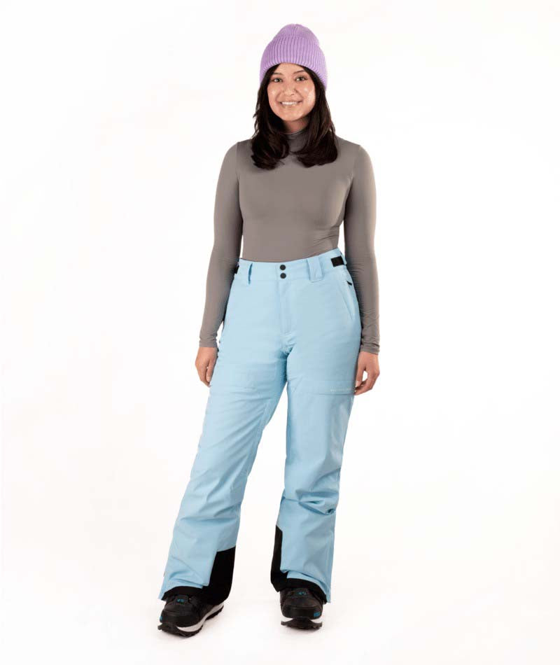 WZoeIIPant-Person wearing light blue snow pants and a gray top with a white background