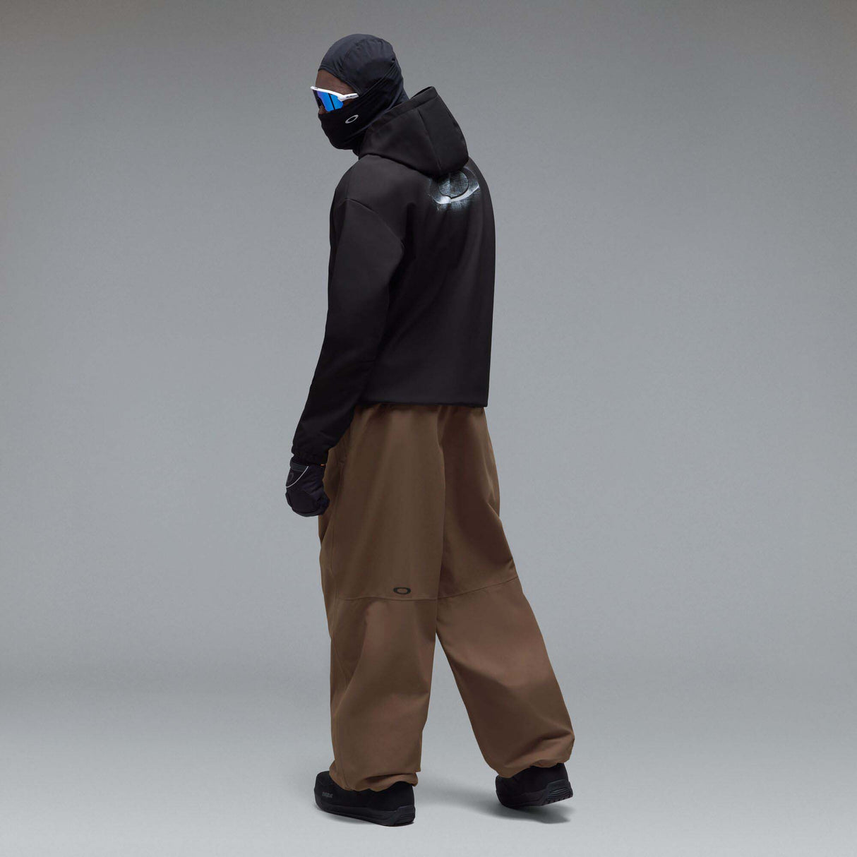 WintertideScratchedHoodie-A black pullover hoodie with a small white Oakley logo on the left chest, displayed against a neutral gray gradient background.
