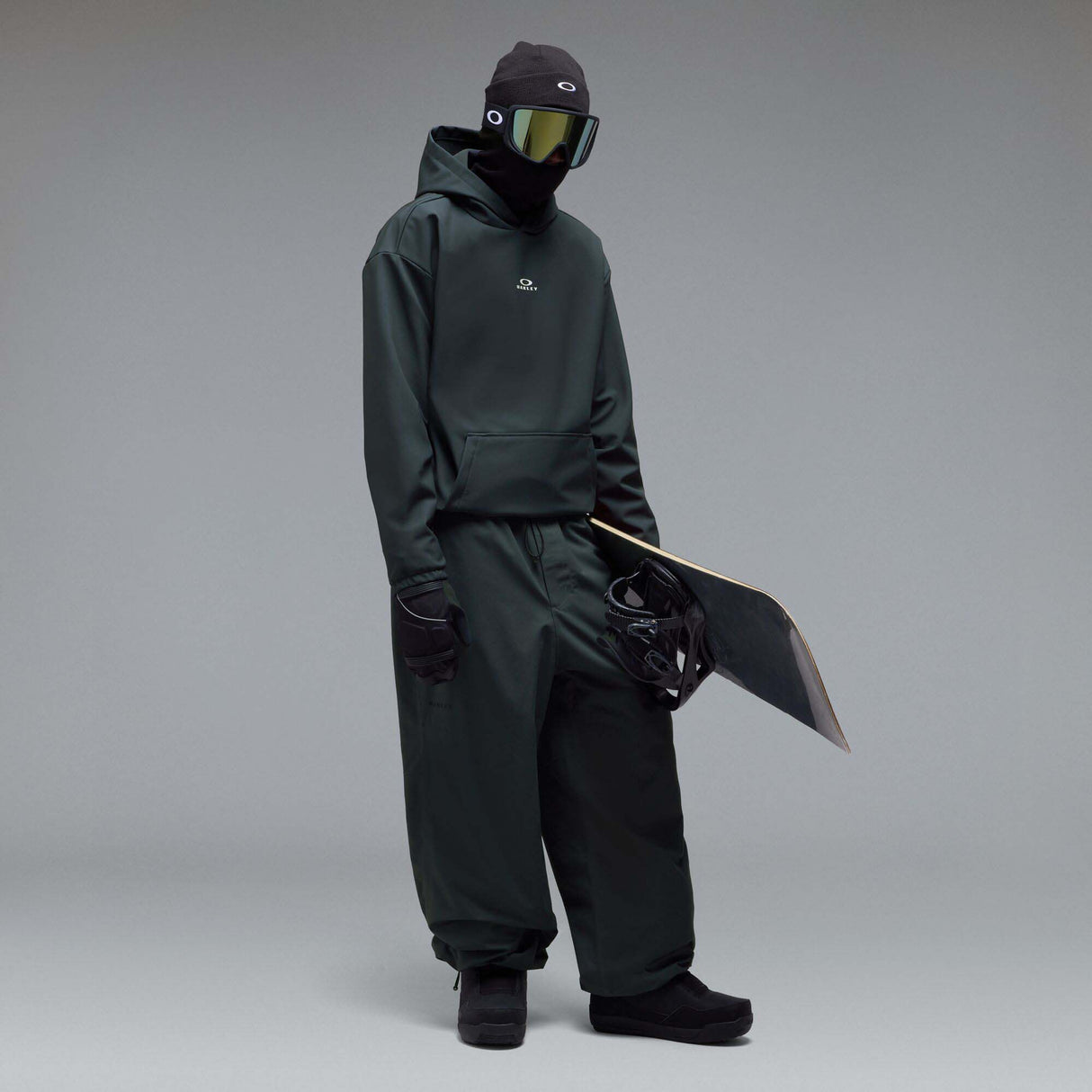 WintertideScratchedHoodie-A dark charcoal gray hooded sweatshirt with a small white Oakley logo on the left chest, displayed against a neutral gray gradient background.