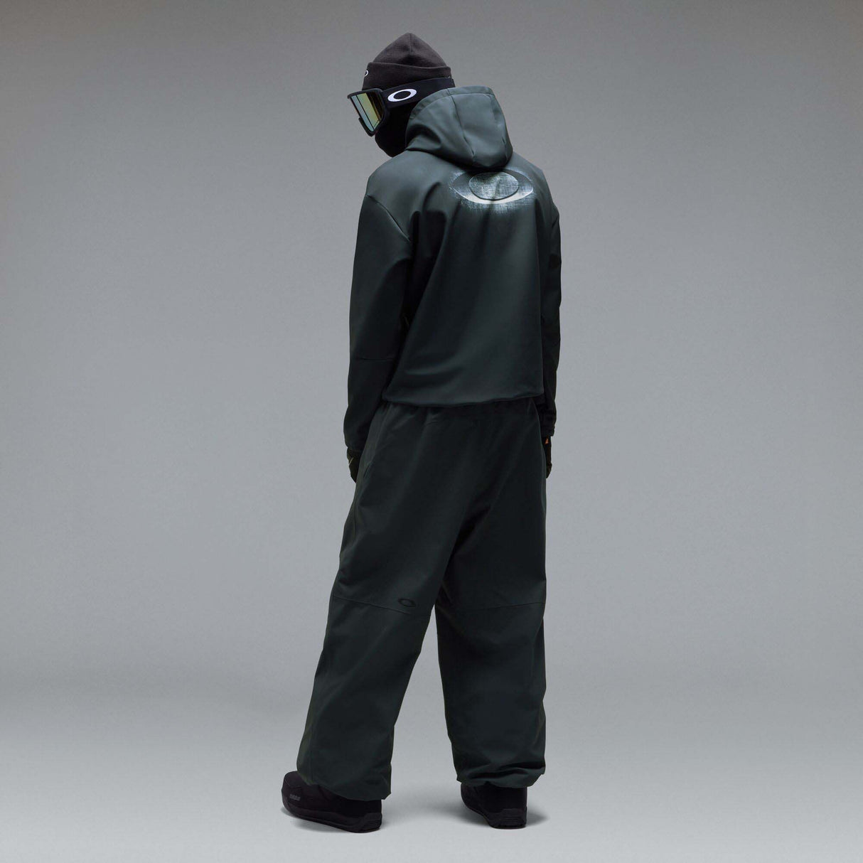 WintertideScratchedHoodie-A dark charcoal gray hooded sweatshirt with a small white Oakley logo on the left chest, displayed against a neutral gray gradient background.