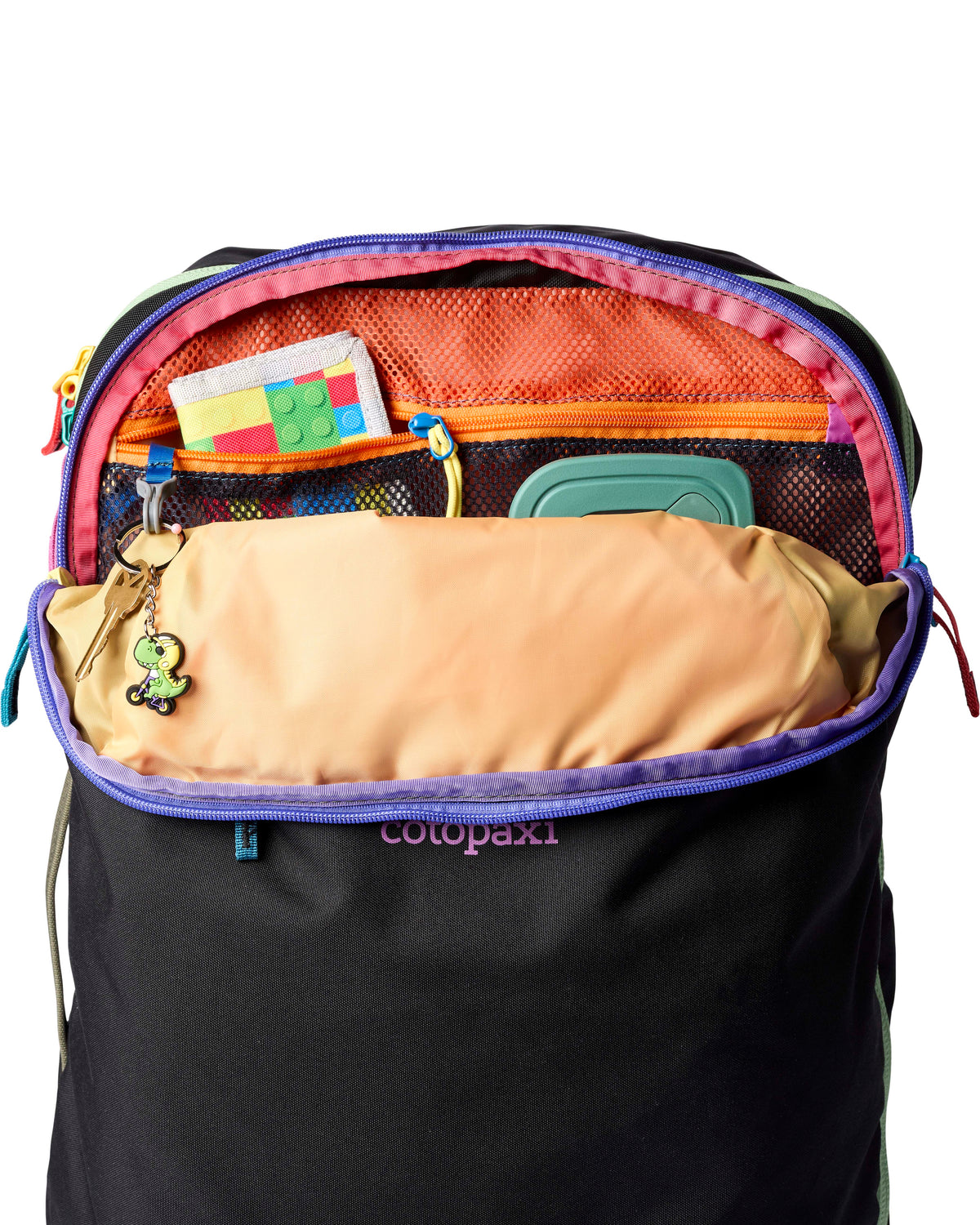 allpa-35l-travel-pack-A black Cotopaxi backpack with a pink llama logo on the front, accented with bright blue, purple, and multicolor zipper details, shown on a white background.